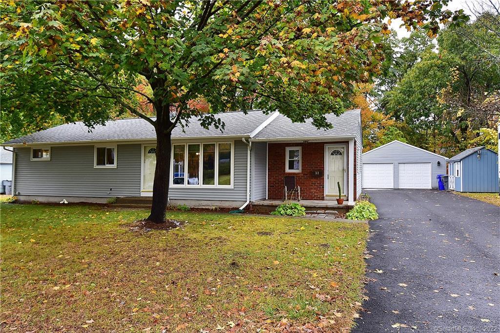 32 Tabor Road Enfield, CT 06082 - Photo 1 of 1 a front view of a house with a garden and porch