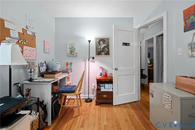 a view of a workspace with furniture and wooden floor