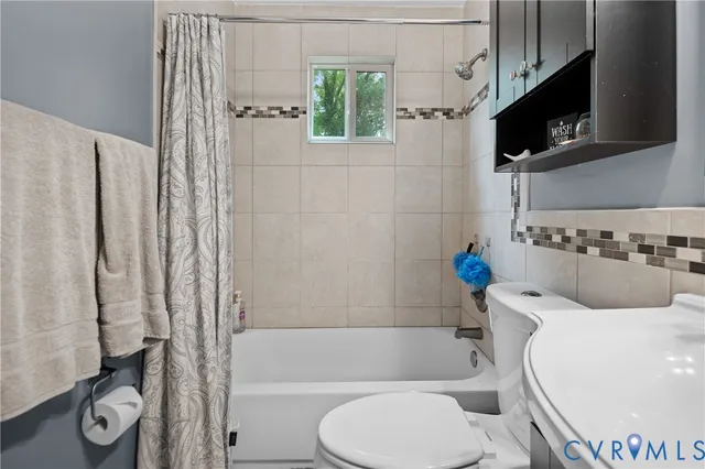 a bathroom with a toilet a sink and bathtub