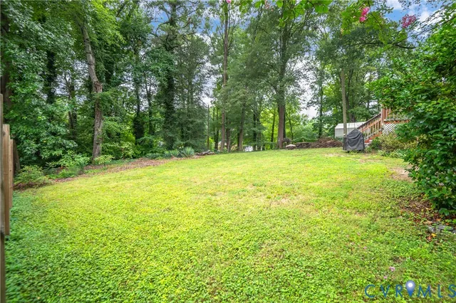 a view of a field with trees in the background