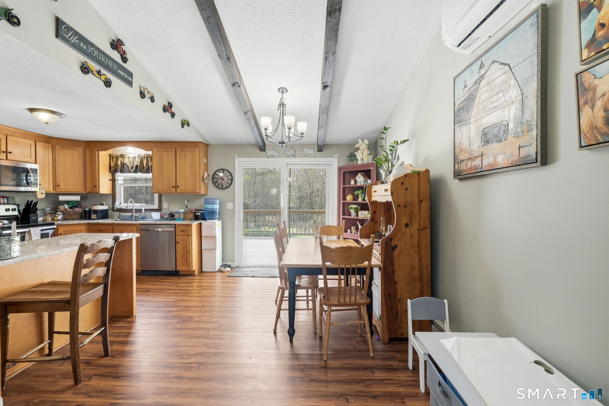 264 Quaddick Town Farm Road Thompson, CT 06277 - Photo 16 of 35 a kitchen with stainless steel appliances wooden floor and dining table