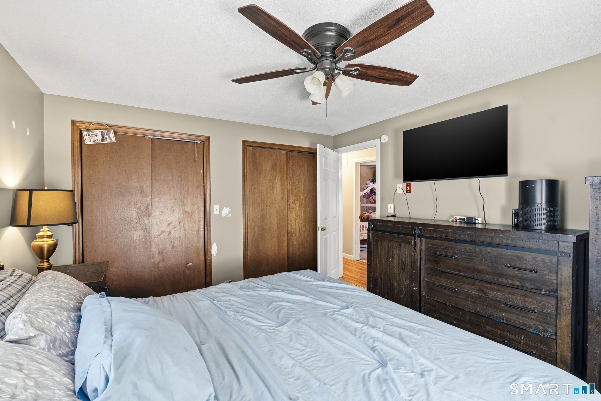 264 Quaddick Town Farm Road Thompson, CT 06277 - Photo 23 of 35 a bedroom with a bed and a flat screen tv