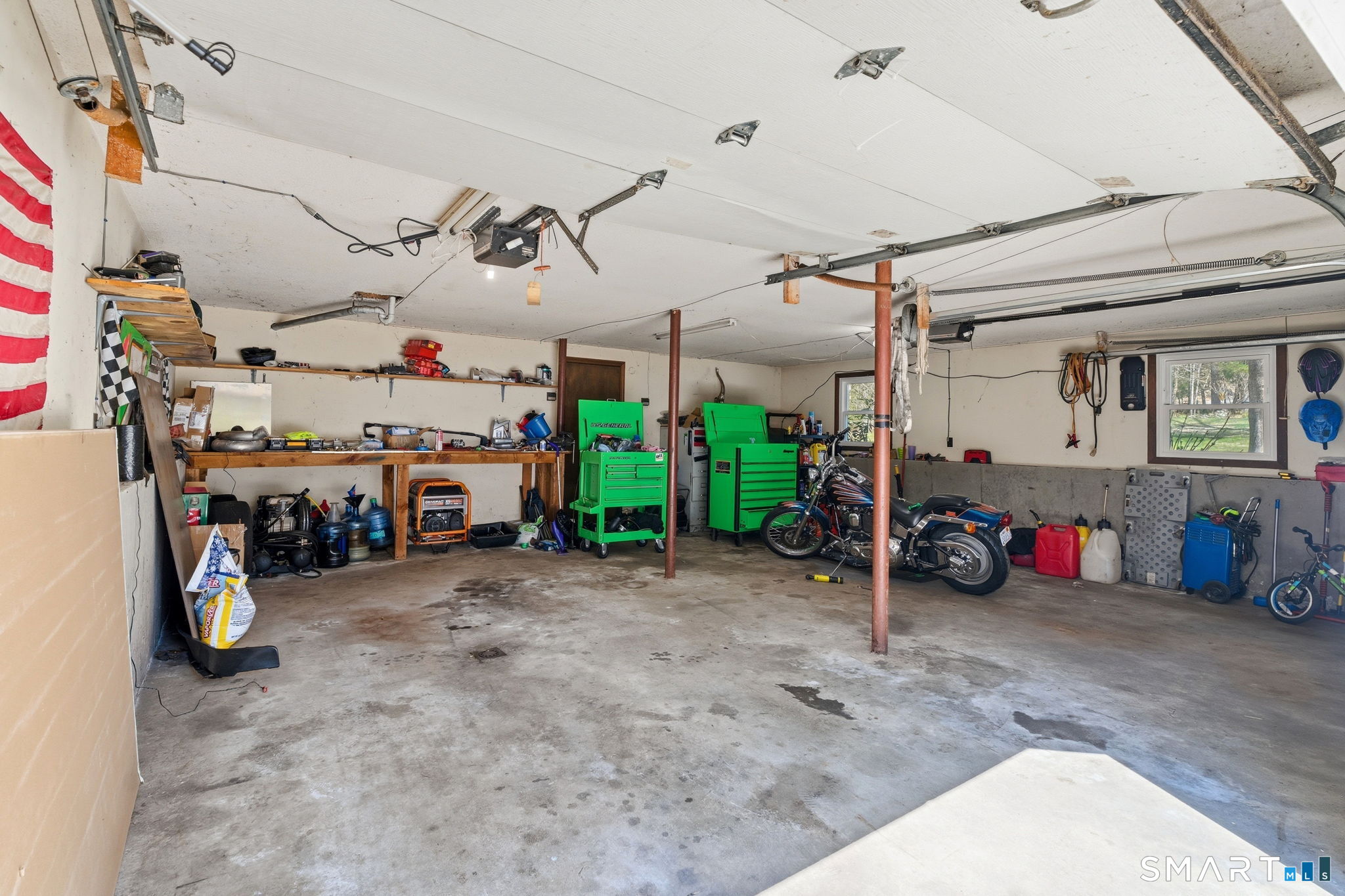 264 Quaddick Town Farm Road Thompson, CT 06277 - Photo 26 of 35 a view of a garage with a bike and a car