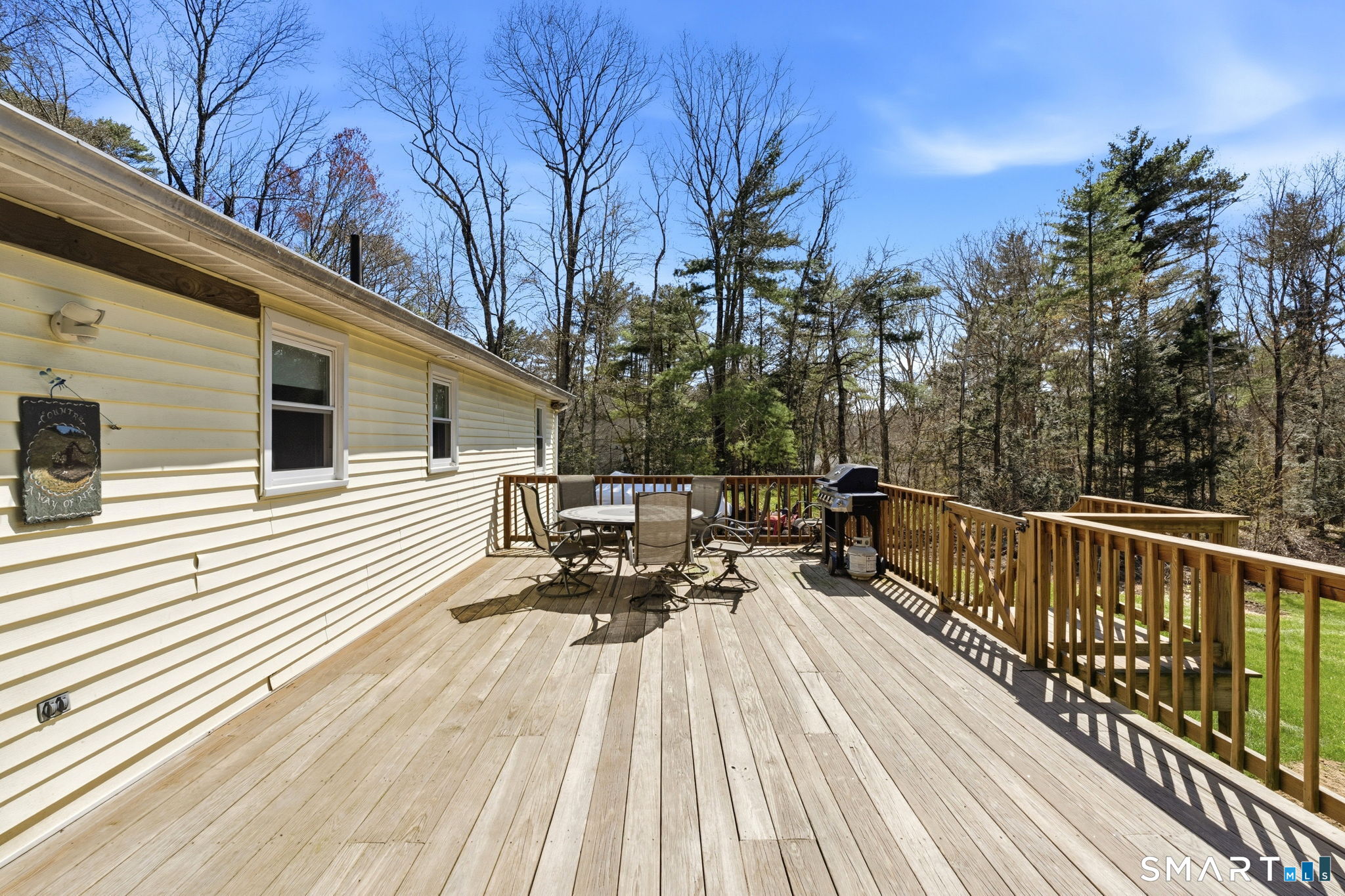 264 Quaddick Town Farm Road Thompson, CT 06277 - Photo 7 of 35 a view of a wooden deck with chairs
