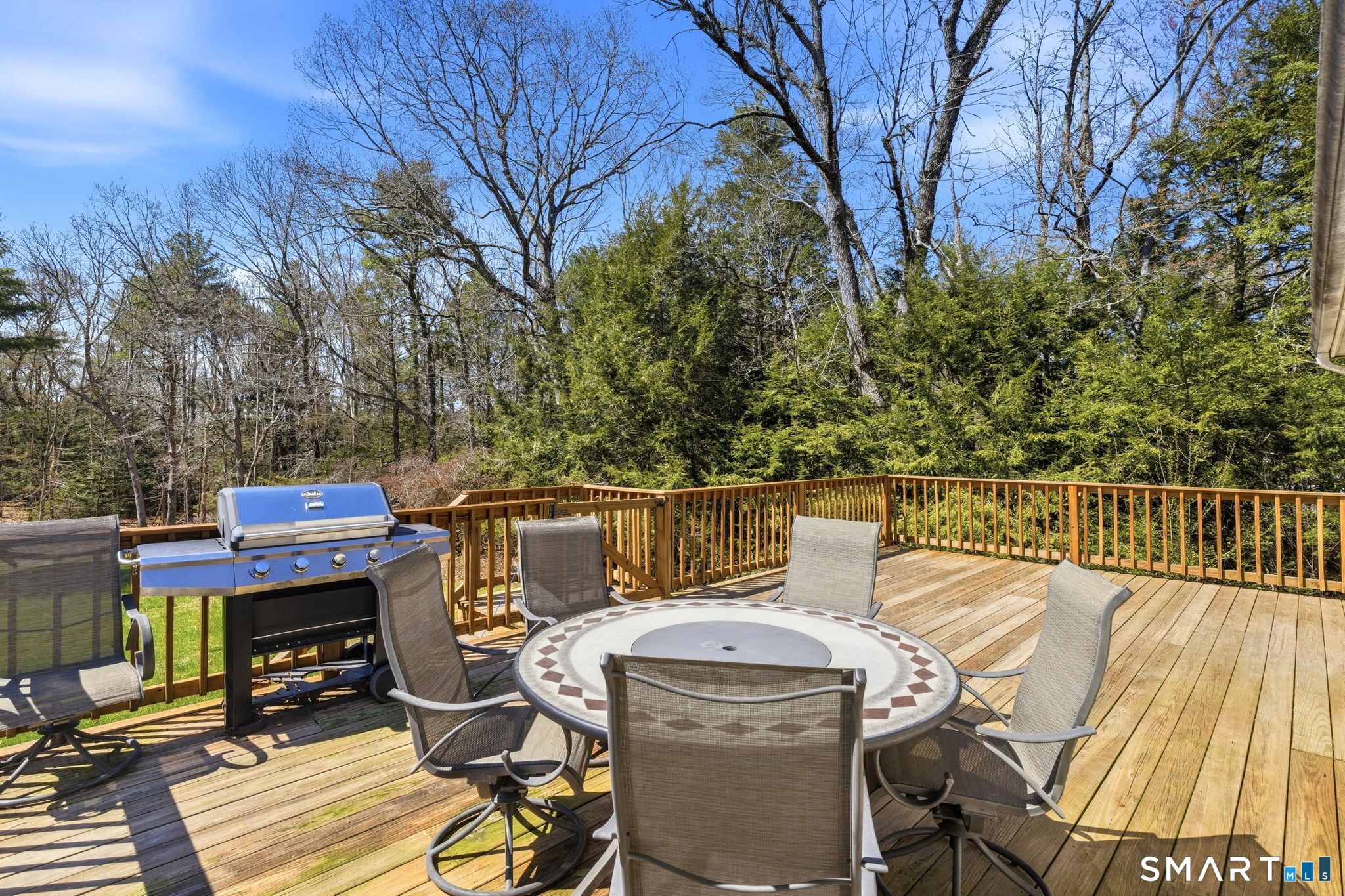 264 Quaddick Town Farm Road Thompson, CT 06277 - Photo 8 of 35 a view of a deck with two chairs and a table