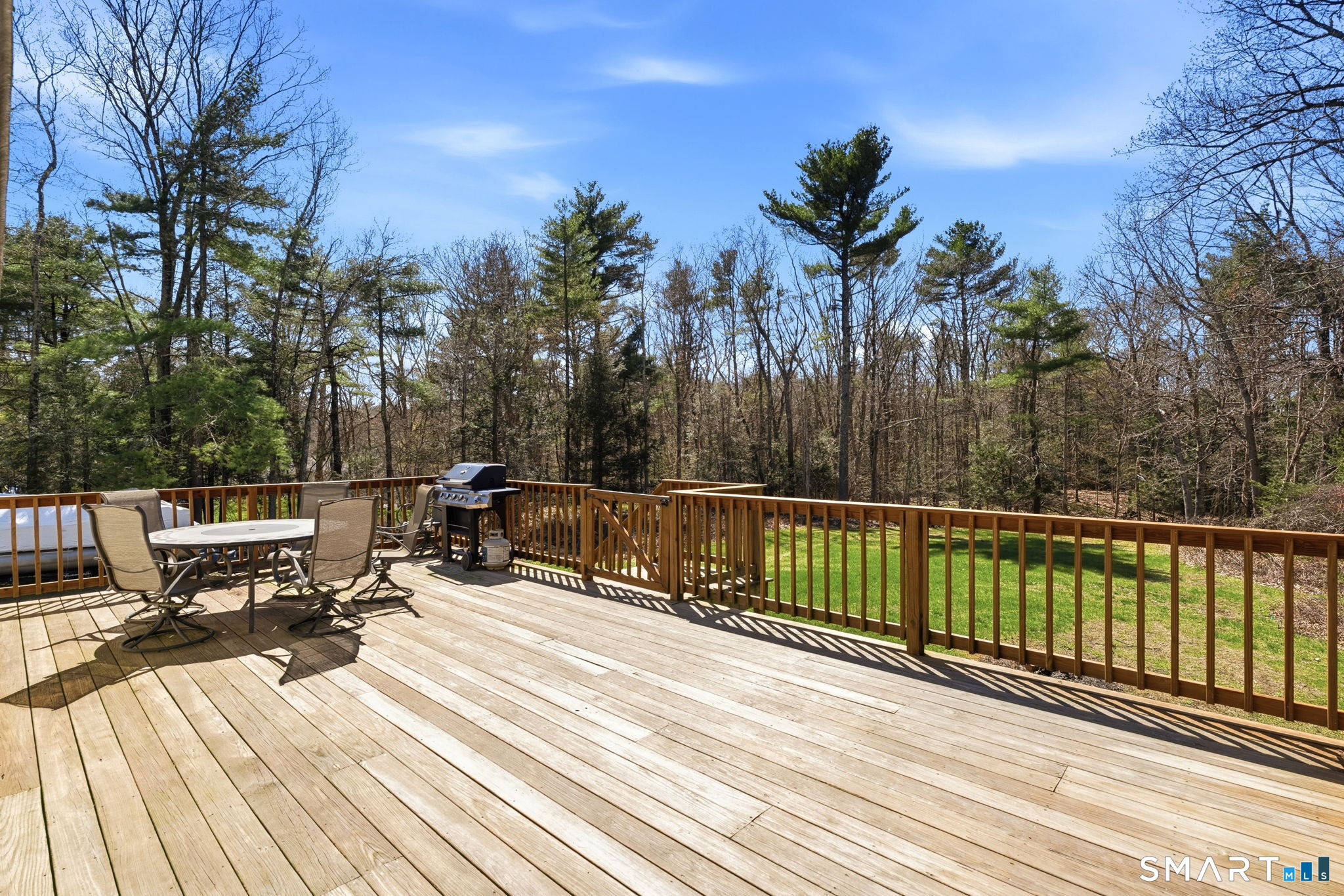 264 Quaddick Town Farm Road Thompson, CT 06277 - Photo 9 of 35 a view of a balcony with chairs and wooden floor
