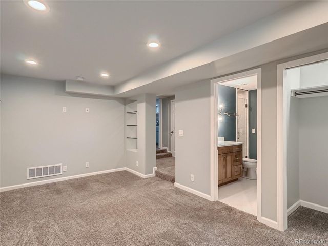 a bathroom with a sink toilet vanity and shower