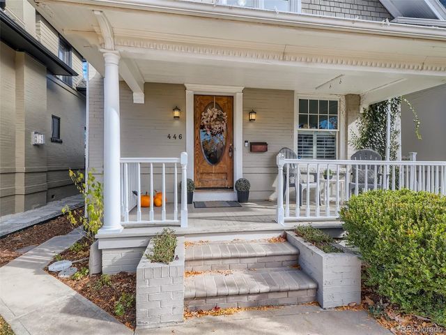 a front view of a house with a garden