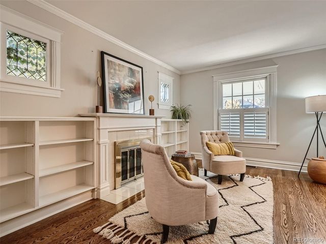 a living room with furniture a fireplace and a window