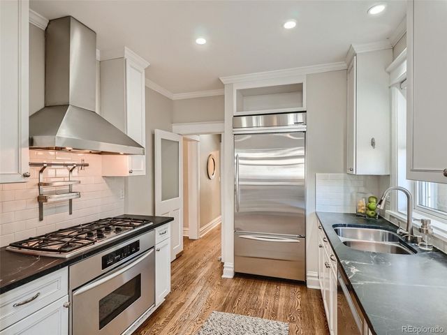 a kitchen with a stove and a refrigerator