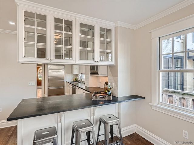 a kitchen with a table chairs and a refrigerator