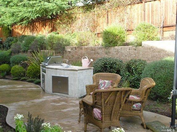 3 Valleyview Terrace Novato, CA 94949 - Photo 1 of 1 a view of a patio with table and chairs potted plants with wooden fence