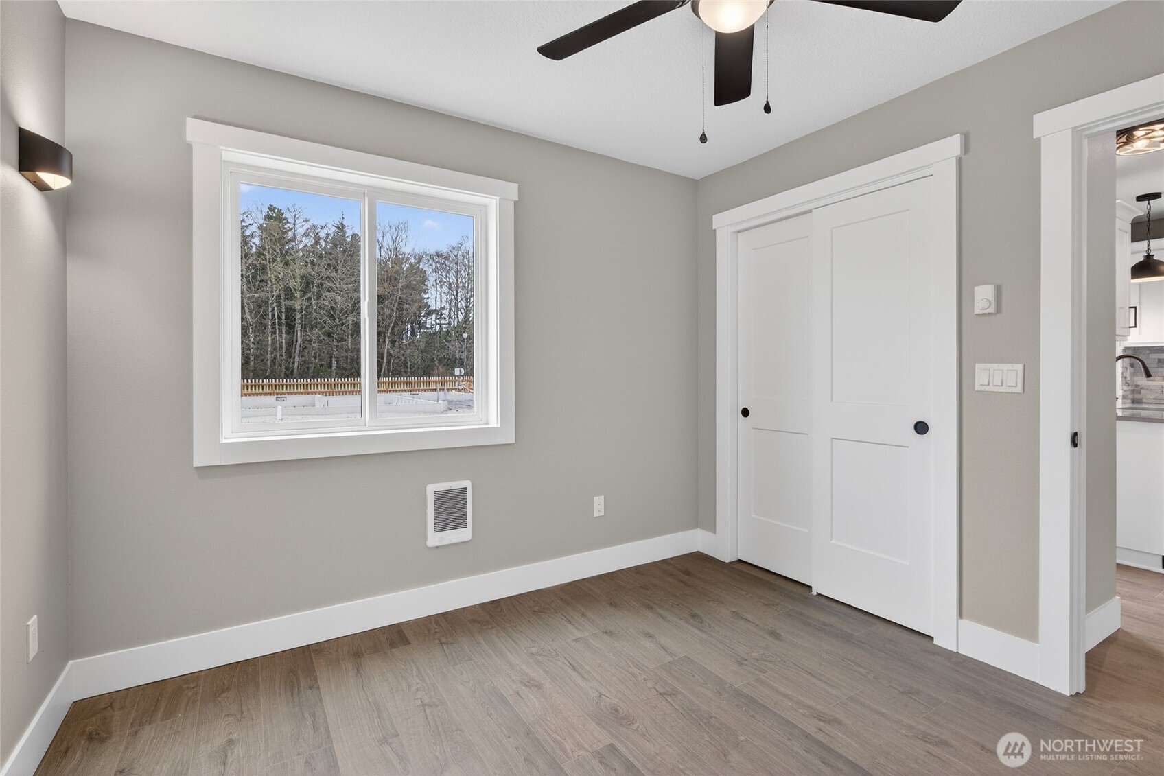 109 7th Street Southwest Long Beach, WA 98631 - Photo 11 of 22 a view of an empty room with a window and wooden floor