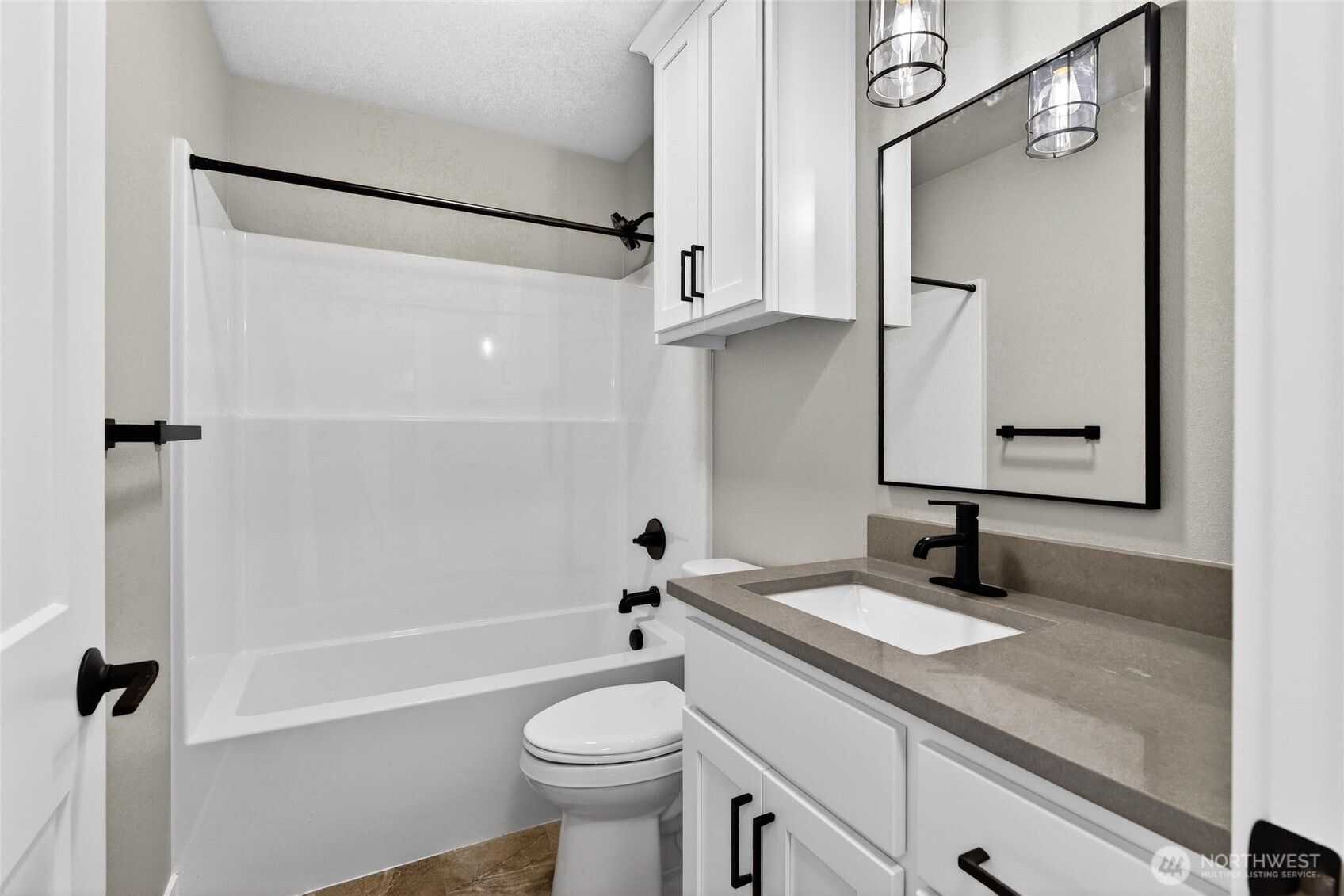 109 7th Street Southwest Long Beach, WA 98631 - Photo 12 of 22 a bathroom with a granite countertop sink toilet and shower