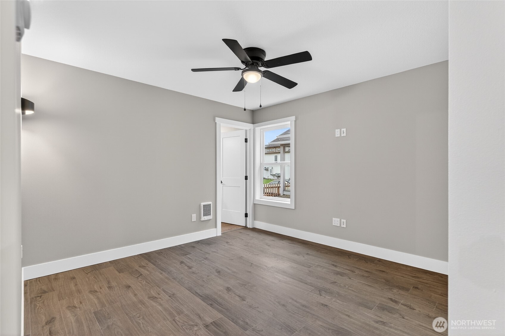 109 7th Street Southwest Long Beach, WA 98631 - Photo 14 of 22 an empty room with wooden floor ceiling fan and window