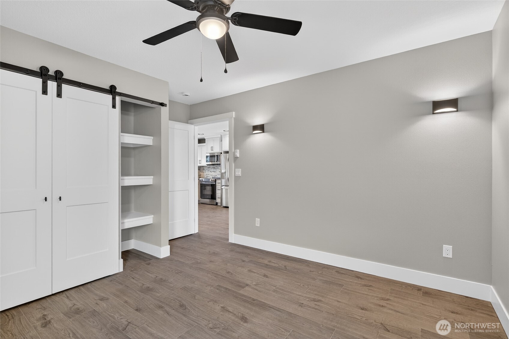 109 7th Street Southwest Long Beach, WA 98631 - Photo 17 of 22 a view of empty room with wooden floor and ceiling fan