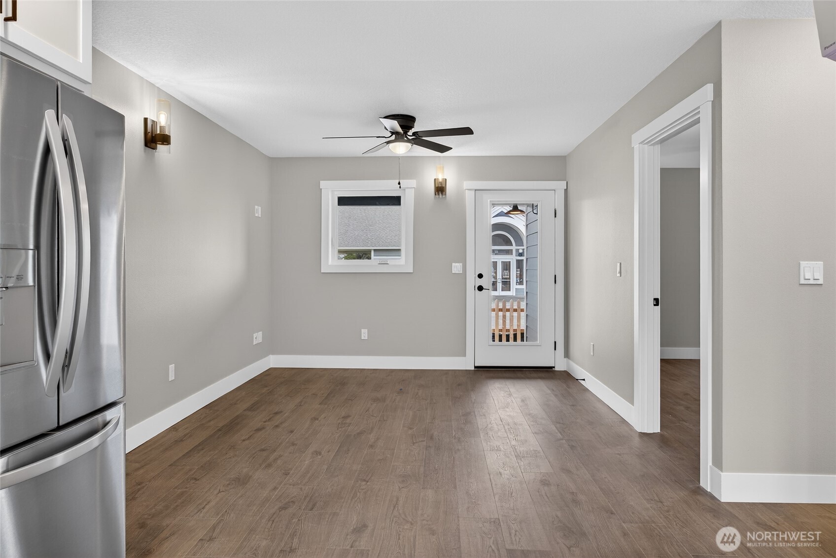 109 7th Street Southwest Long Beach, WA 98631 - Photo 5 of 22 an empty room with windows and a ceiling fan