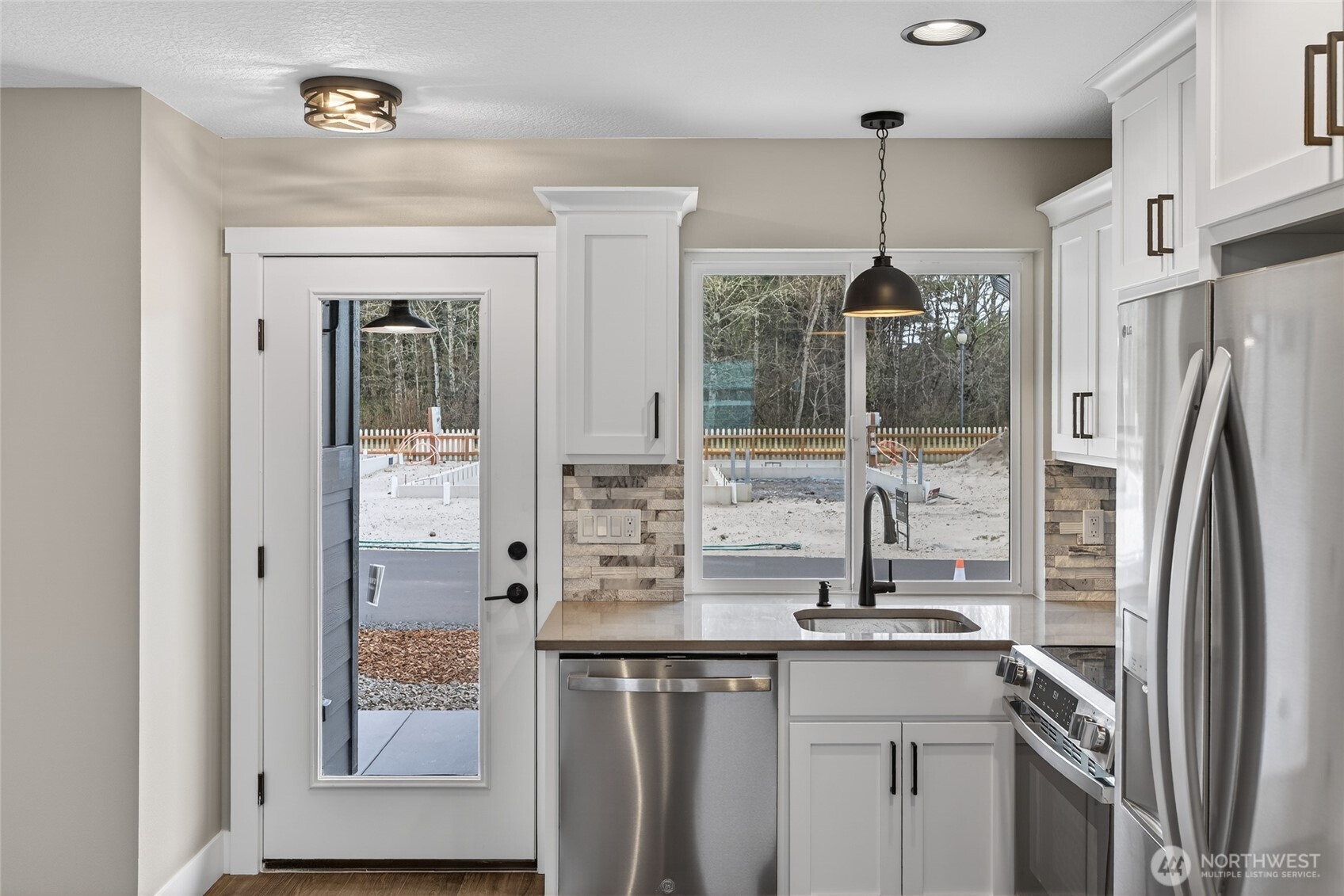 109 7th Street Southwest Long Beach, WA 98631 - Photo 6 of 22 a kitchen with stainless steel appliances a refrigerator and a sink