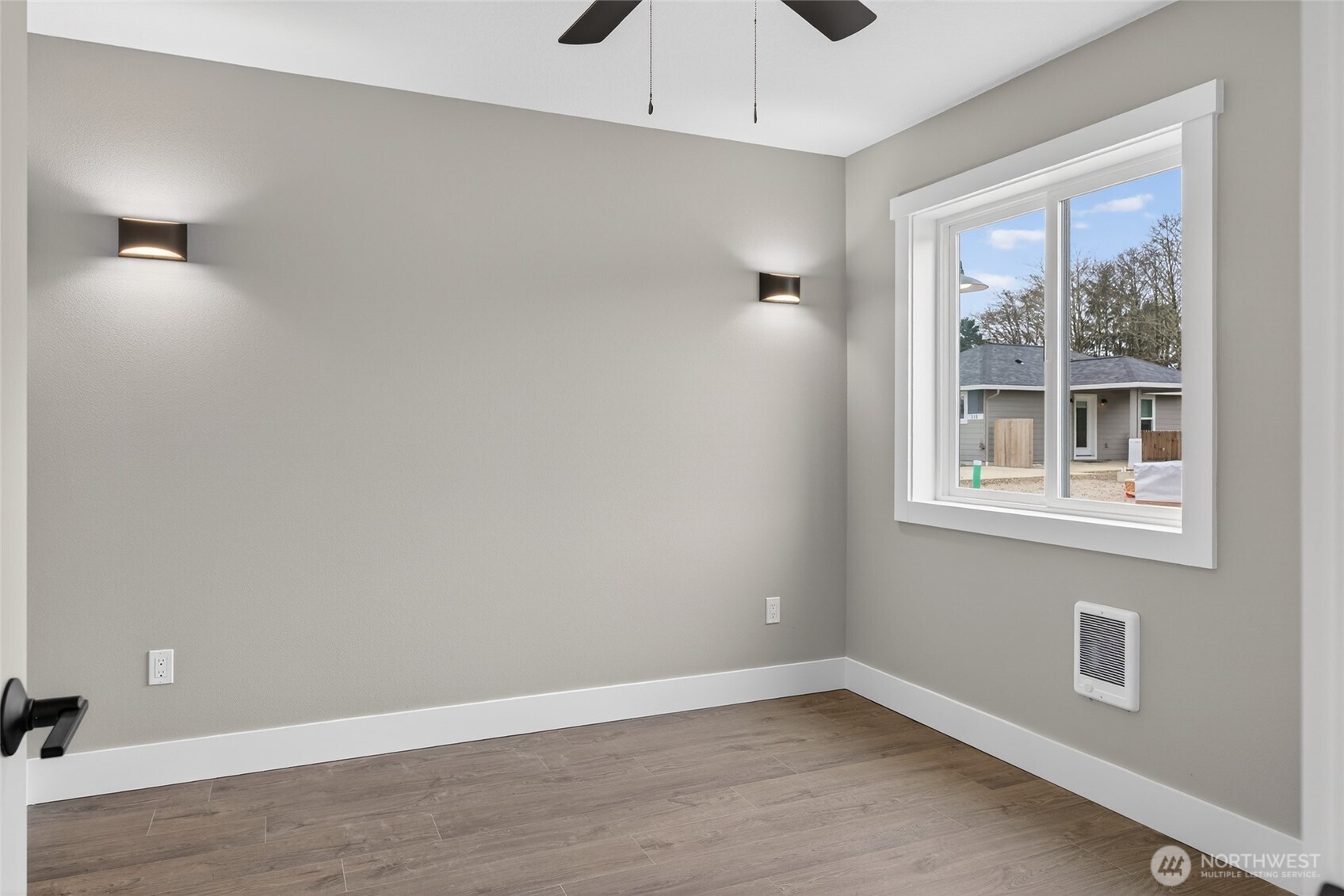 109 7th Street Southwest Long Beach, WA 98631 - Photo 9 of 22 a view of an empty room with a window and wooden floor