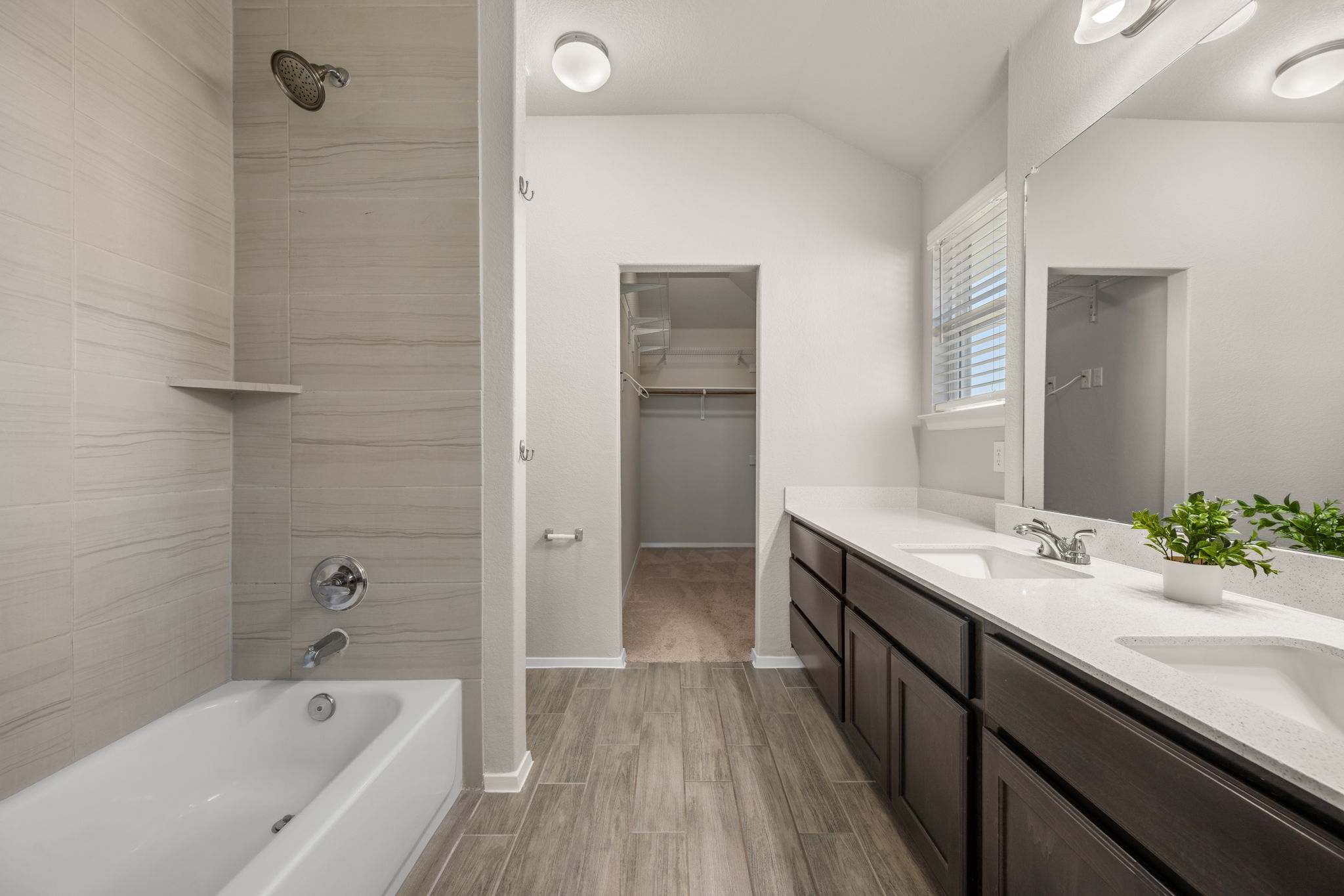 215 Lake Placid Run Elgin, TX 78621 - Photo 4 of 29 A spacious vanity and tile shower highlight this modern primary bathroom.