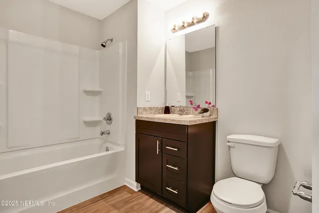 a bathroom with a sink vanity mirror and toilet