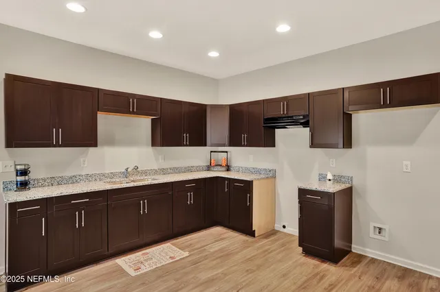 a kitchen with stainless steel appliances sink a microwave and cabinets