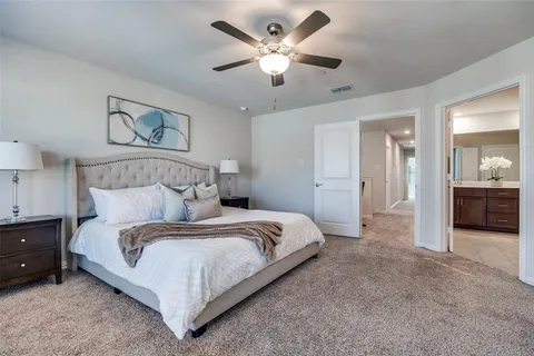 a bedroom with a bed and a chandelier