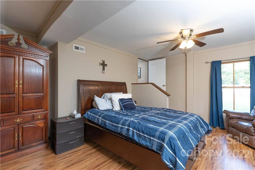 3029 State Highway 55 Clover, SC 29710 - Photo 8 of 34 a bedroom with a large bed and a chandelier
