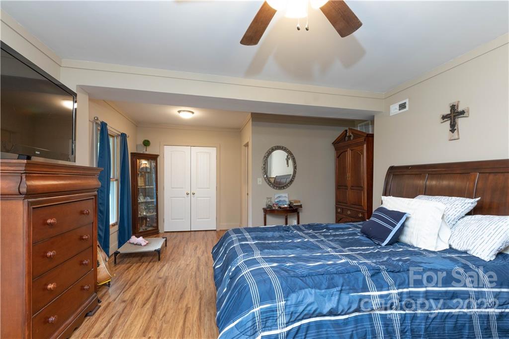 3029 State Highway 55 Clover, SC 29710 - Photo 9 of 34 a bedroom with a bed and a flat tv screen on dresser