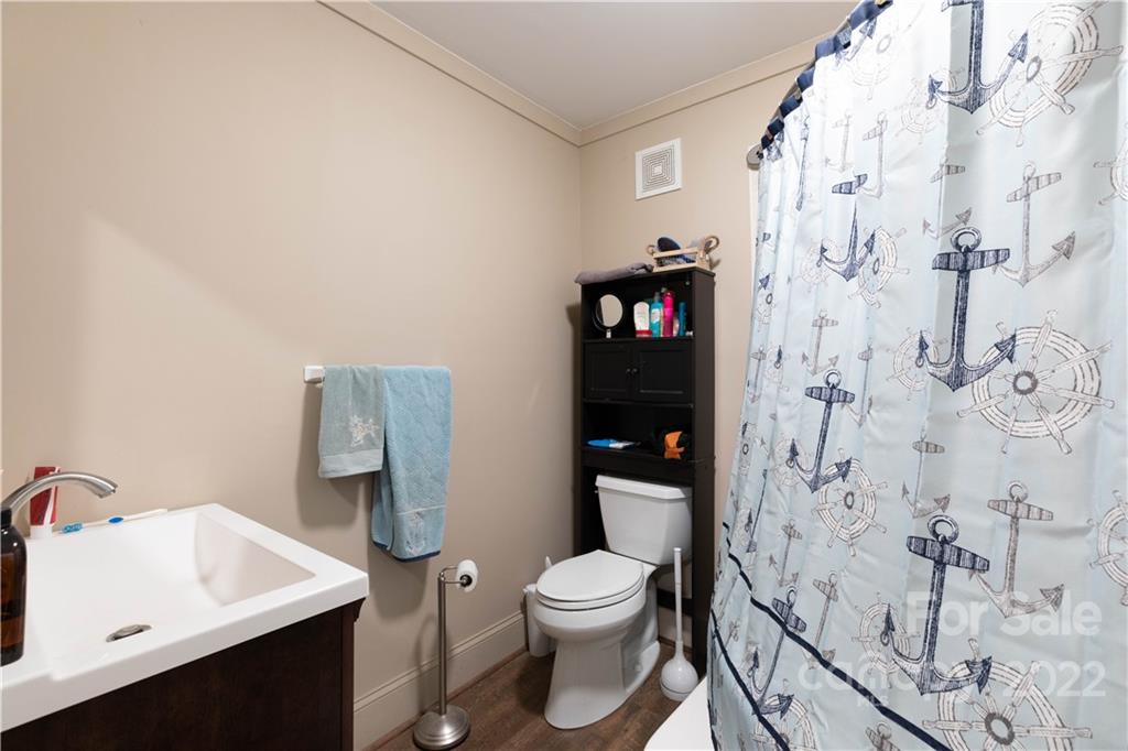 3029 State Highway 55 Clover, SC 29710 - Photo 10 of 34 a white toilet sitting next to a bathroom sink