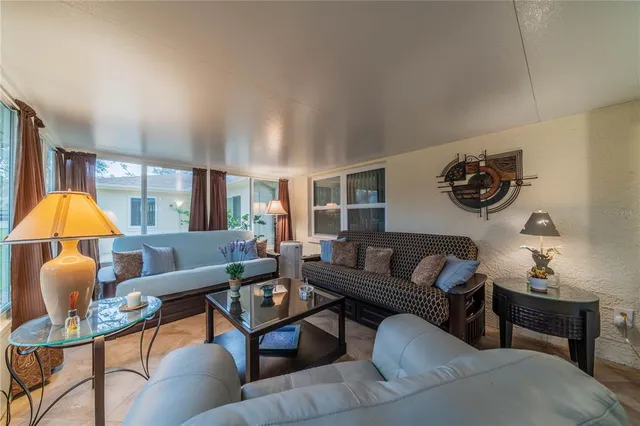 a living room with furniture a fireplace and a chandelier