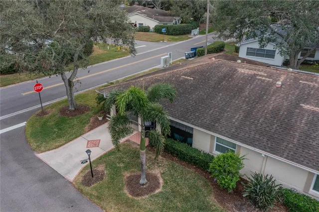 an aerial view of a house with garden space and a street view
