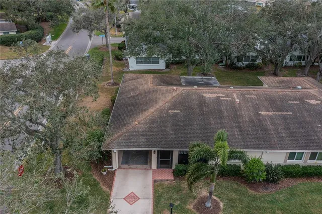 an aerial view of a house with a yard