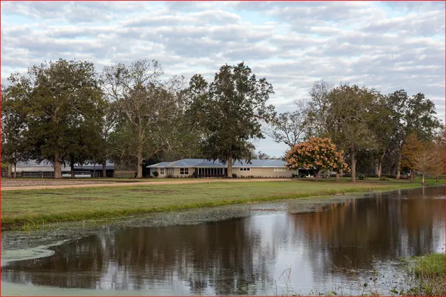 a view of a lake with a house in the background