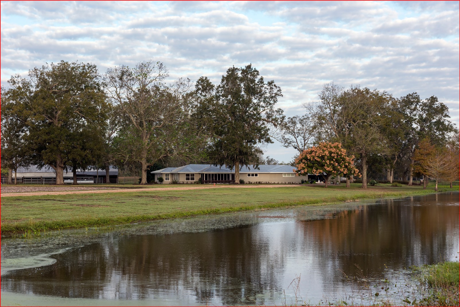 a view of a lake with a house in the background