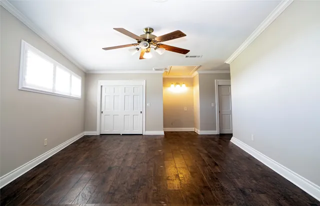 a view of a livingroom with wooden floor and window