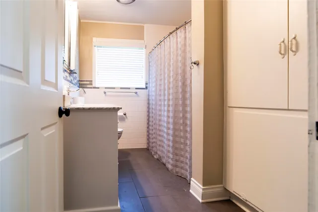 an aerial view of residential houses with outdoor space and trees