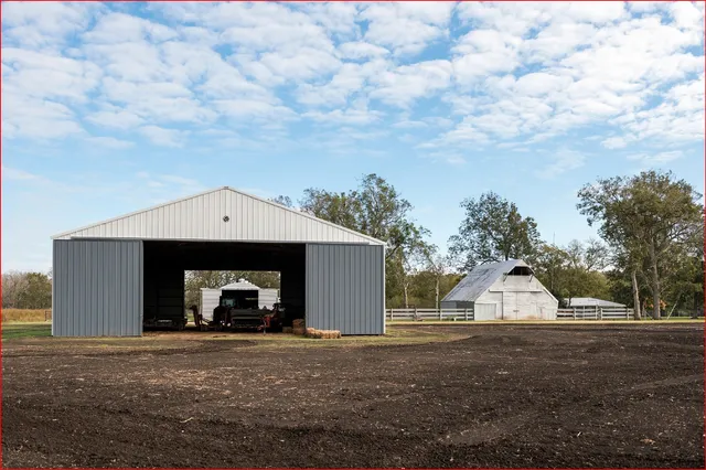 a view of a yard with wooden fence and a bench