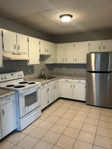a kitchen with a white cabinets and white appliances