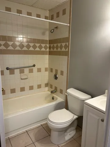 a white toilet sitting next to a bathroom sink