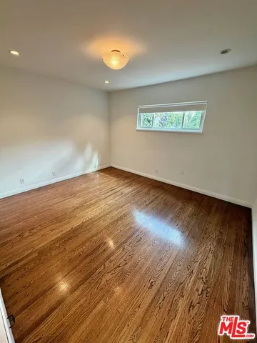 a view of an empty room and a window