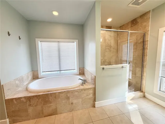 a bathroom with a tub and shower