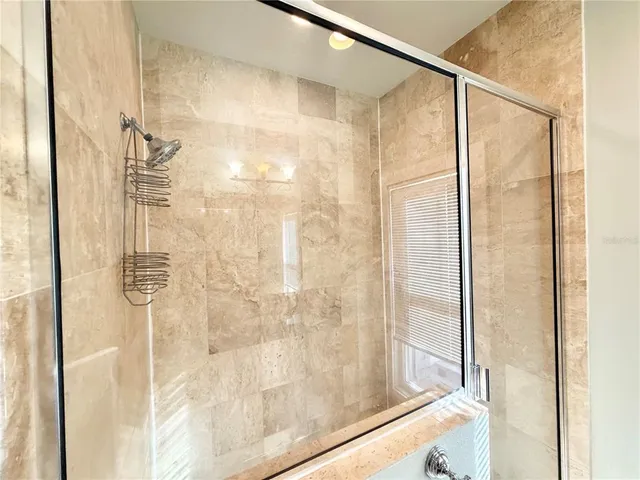 a bathroom with a glass shower door