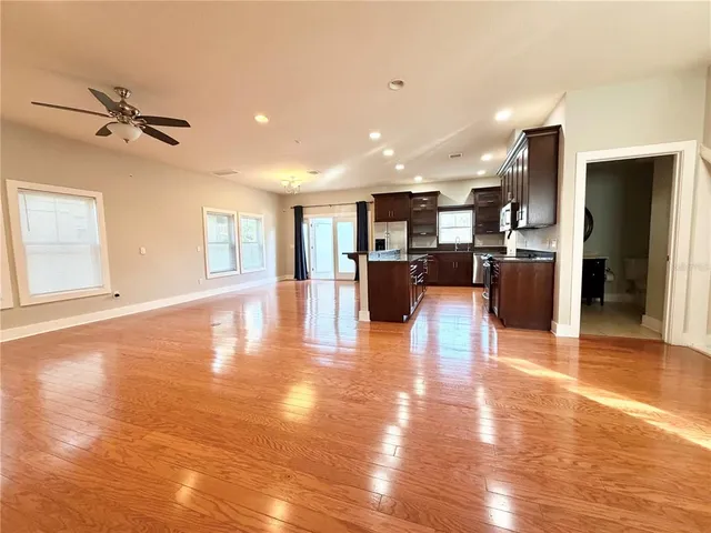 a view of a living room and kitchen with stainless steel appliances