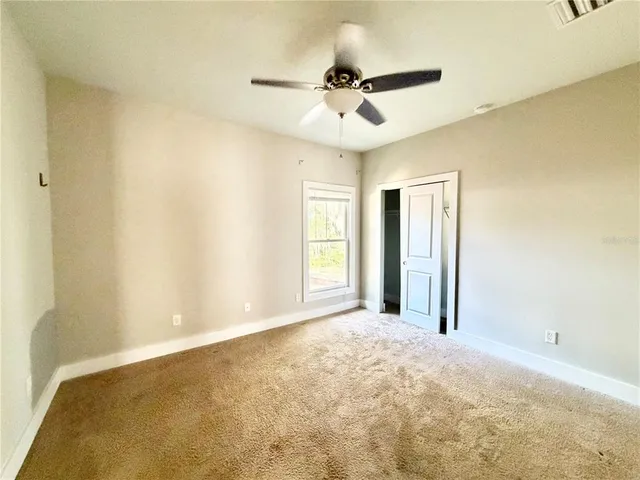 a spacious bathroom with a double vanity sink and a mirror