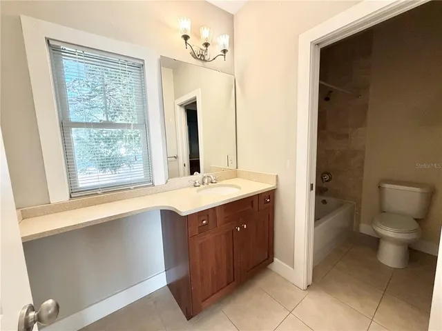 a view of a livingroom with a ceiling fan and window