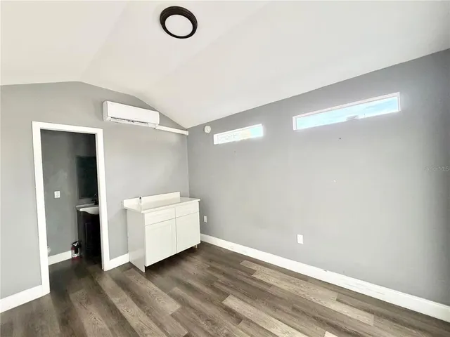 a view of swimming pool on a sunny day with lawn chairs