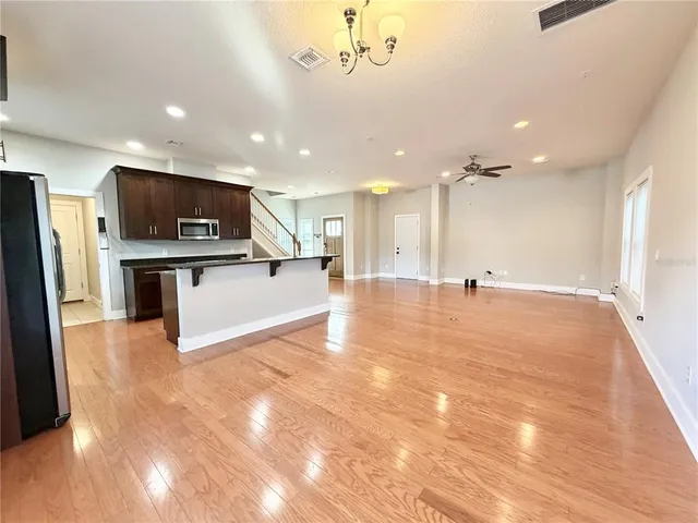 a view of an empty room with kitchen appliances and a window