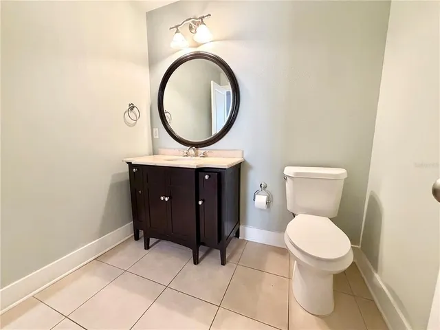 a bathroom with a toilet a sink and a mirror