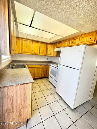 a kitchen with a sink a refrigerator and washer